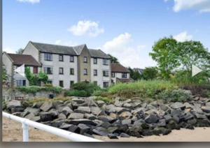 a pile of rocks in front of a building at 3 Bedroom harbourside apartment, Queensferry, 10 miles from Edinburgh in Queensferry