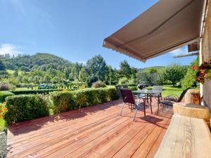 a wooden deck with a table and chairs on it at Chalupa U Josefa 