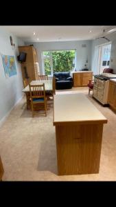 a kitchen and living room with a table and chairs at The Piano House in Carlow