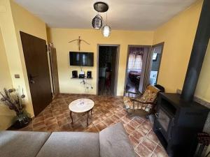 a living room with a table and a fireplace at casa carmiña in Ourense +13 photos