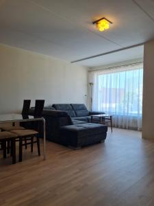 a living room with a couch and a table at Cozy one bedroom apartment in city center in Tallinn