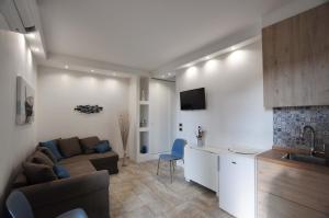 a kitchen and a living room with a couch and a table at Dalila's Apartment in Sirmione