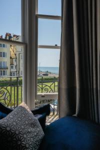 a room with a window with a view of the ocean at Square Townhouse in Brighton & Hove