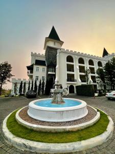 a fountain in front of a large building at Blue Sky Khao Kho Castell Condo in Campson