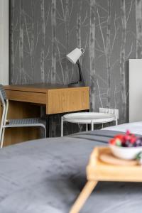a bedroom with a bed with a desk and chairs at Green View Apartment with Balcony Winogrady by Noclegi Renters in Poznań