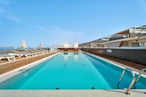 a large blue swimming pool on top of a building at Suite Mirador del Galeón in Adeje