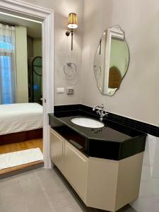 a bathroom with a sink and a mirror at Blue Sky Khao Kho Castell Condo in Campson