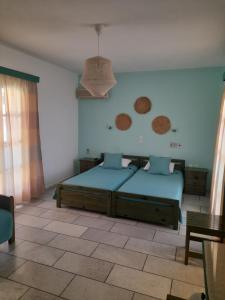 a bedroom with two beds and a table at Kapares Studios in Agia Anna Naxos