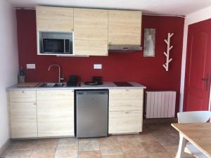 a kitchen with a sink and a dishwasher at Le Jacquéron in Le Agnets
