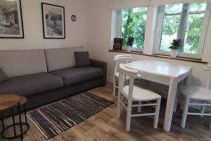 a living room with a couch and a table at FairSchlafen - Gartenwohnung in Bücken