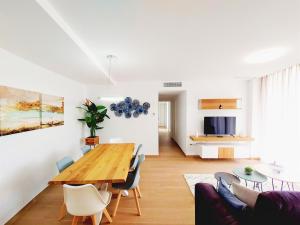 a dining room and living room with a table and chairs at Anacasa Denia Beach AP8209 in Denia