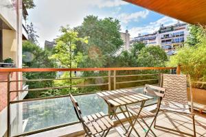 a balcony with two chairs and a table on a balcony at Studio - Appartement Quartier Montparnasse 2 in Paris