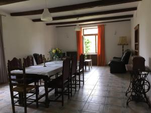 comedor con mesa, sillas y ventana en Maison du Bûcheron, en Melay