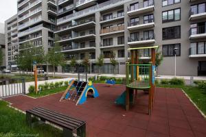 a playground in front of a apartment building at Apartimento Angel River 7 in Wrocław