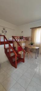 a living room with a staircase and a table at Filoxenia Apartments in Mytilene