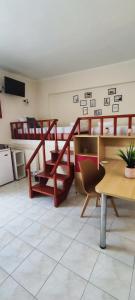 a room with bunk beds and a table and chairs at Filoxenia Apartments in Mytilene