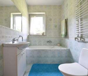 a bathroom with a tub and a sink and a toilet at Dom wśród Modrzewi in Uście Gorlickie +21 photos