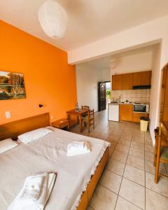 a large room with two beds and a kitchen at Lofos ClaudiAgapi Guesthouse Seaview in Agios Stefanos