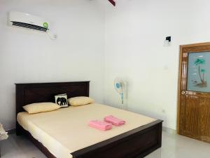 Postel nebo postele na pokoji v ubytování Harini Villa