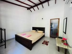 Postel nebo postele na pokoji v ubytování Harini Villa