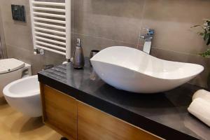 a bathroom with a large white sink on a counter at Casa Relax - 500 mt. dal Centro in Turin +12 photos