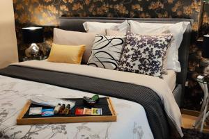 a bed with a tray on it with pillows at Casa Relax - 500 mt. dal Centro in Turin