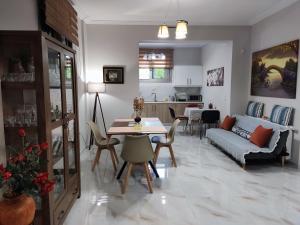 a living room with a table and a couch at Ebony and Ivory Suites in Drosia