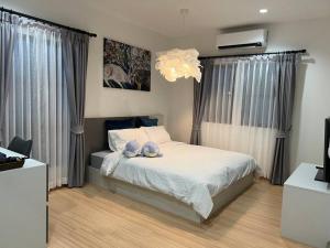 a bedroom with a bed with two pillows on it at MOST Family 456/66 Ubon-Thailand in Ubon Ratchathani