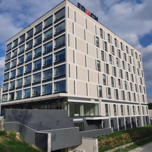 a large white building with a lot of windows at Centrum Prusa Prestige 211 in Lublin