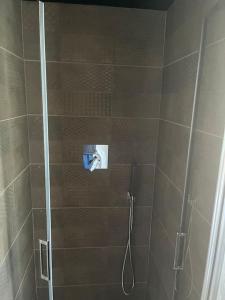 a shower with a glass door with a shower at Al Buffardel in Bagnone
