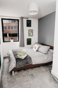 a bedroom with a large bed in front of a window at Modern Centre of the city 1 bedroom apartment in Sheffield