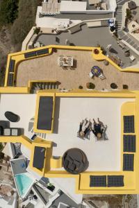 an overhead view of two people sitting on a boat at Ilivatos in Oia