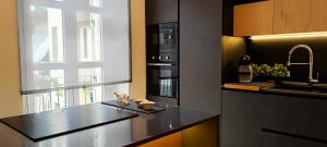 a kitchen with a black counter top and a window at Casa Relax - 500 mt. dal Centro in Turin