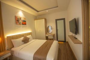 Postel nebo postele na pokoji v ubytování Torino Hotel Dalat