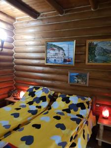 a bedroom with a bed and a wooden wall at Barbu Ionel in Băile Herculane +55 photos