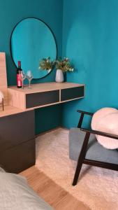 a bedroom with a table with a mirror and a chair at Kitty in Povljana