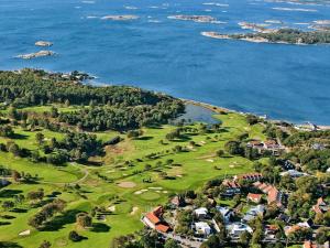 an aerial view of a golf course next to the ocean at Studio Hamra in Särö