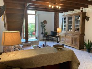 a living room with a couch and a table at Les Fontaines du Mas des Fontaines in Montagnac