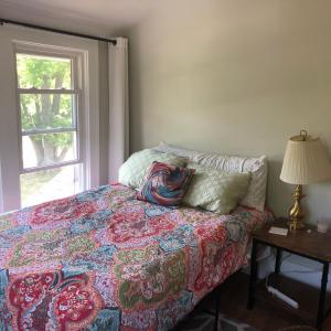 a bedroom with a bed with a pillow and a window at Seabreeze Three Bedroom Home in Rochester