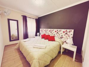 a bedroom with a large bed with red pillows at Fonda Aparicio in Fuentespalda