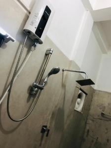 a shower head in a bathroom with a toilet at Cannel view apartment Negombo in Negombo