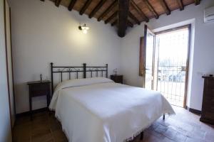 Un pat sau paturi într-o cameră la Agriturismo Pontignanello