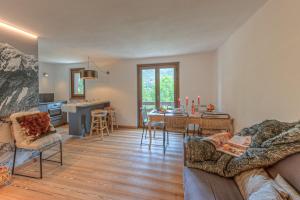 a living room with a couch and a dining room at Casa Joelle in Courmayeur