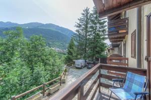 a balcony with chairs and a view of the mountains at Casa Joelle in Courmayeur