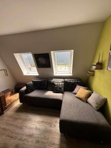 a living room with a couch and two windows at Apartment Luna in Bovec