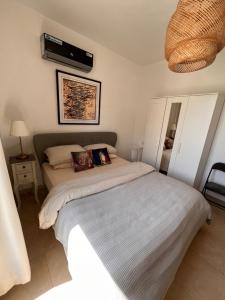 a bedroom with a bed and a fan at The Arabian Oryx in Amman