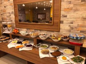 a buffet with many plates of food on a table at Hotel EKA in Constanţa