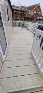 a wooden deck with a bench on a house at Coastfields 3 bed 8 berth holiday home in Ingoldmells