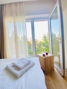 a bedroom with a bed and a large window at Room 27 in Kutaisi in Kutaisi