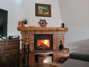 a living room with a brick fireplace with a fire at Las Natillas con V in Martín Miguel